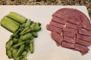 Cutting cucumbers and ham for Japanese potato salad
