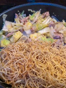 Adding noodles to make Yakisoba