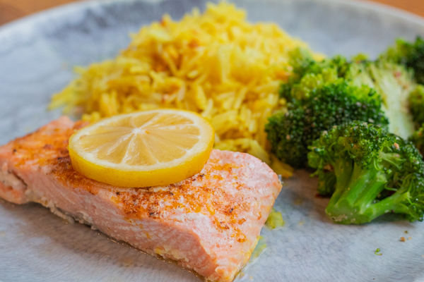 Plate of Hawaiian Salt Lemon Butter Salmon with broccoli and tumeric lemon rice