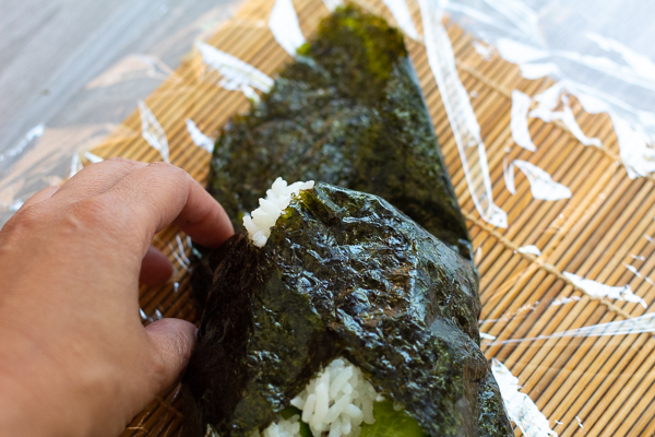 Tucking the corner of nori to make tuna mayo onigirazu